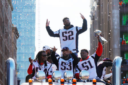 The New England Patriots' Dont'a Hightower (54), Kyle Van Noy (53), Ja'Whaun Bentley (51) and Elandon Roberts (52) ride on flatbed truck during their victory parade after winning Super Bowl LIII, in Boston, Massachusetts, U.S., February 5, 2019. REUTERS/Brian Snyder