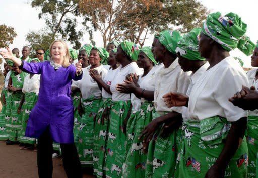 US Secretary of State Hillary Clinton (L) dances with Malawian women at the Lumbadzi Milk Bulking Group in Lilongwe, Malawi. Clinton is to meet with South Africa's anti-apartheid hero Nelson Mandela on Monday, the State Department said, hours after her arrival on the latest leg of her Africa tour