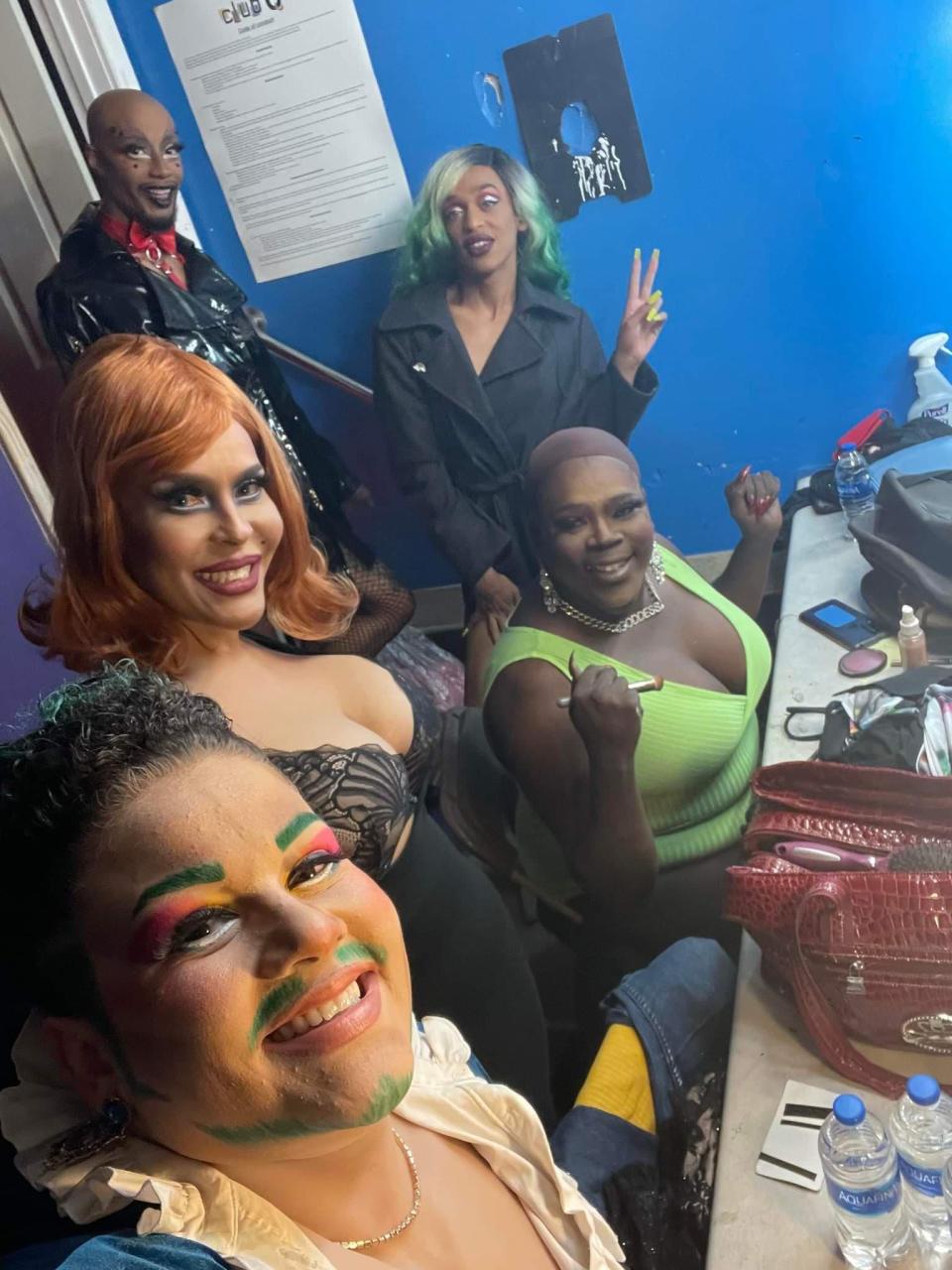 Tiara Kelley (seated first from right) poses with fellow performers inside Club Q in Colorado Springs, Colorado, in this undated photograph. Kelley, who performed at Club Q for the past six months and signed a contract with it roughly four weeks ago, hosted a weekly Friday night drag show at the club.