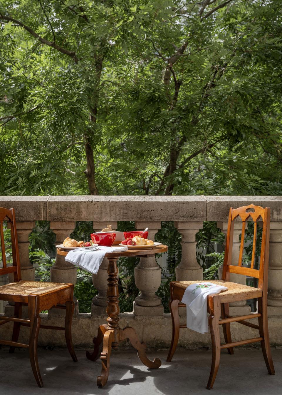 A terrace overlooks the tree-lined street.