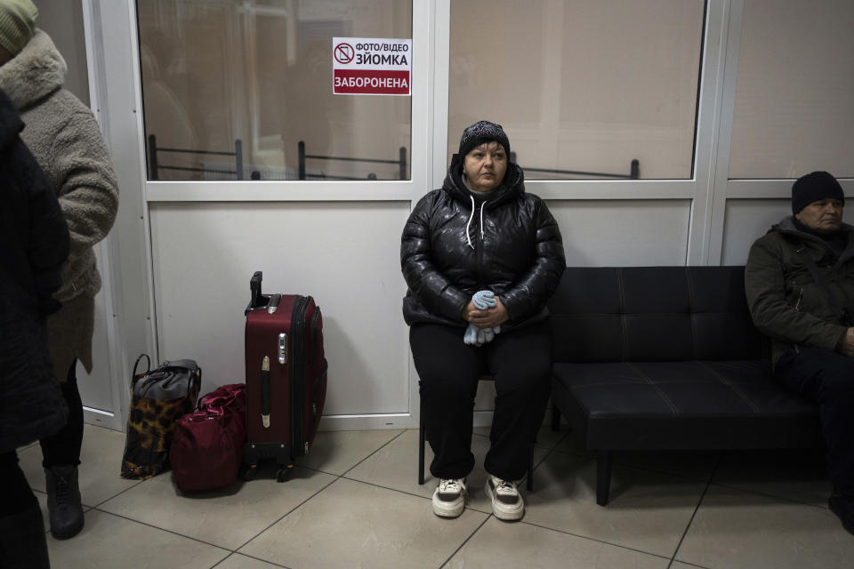 A woman waits for an evacuation bus at a shelter in Sumy, Ukraine, Thursday, Nov. 23, 2023. An average of 80-120 people return daily to Ukraine from territories held by Russia through an unofficial crossing point between the two countries amid a brutal war. Most choose this challenging path, even in freezing temperatures, to escape Russian occupation and reunite with their relatives in Ukraine. (AP Photo/Hanna Arhirova)