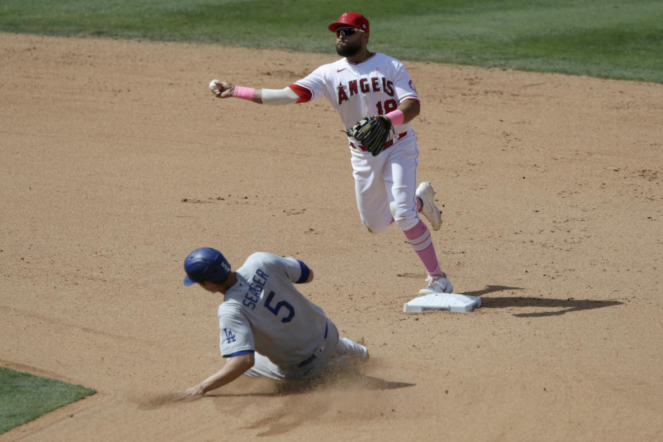 Los Angeles Angels second baseman Jose Rojas throws to first over Los Angeles Dodgers' Corey Seager for a double play on Will Smith during the seventh inning of a baseball game in Anaheim, Calif., Sunday, May 9, 2021. (AP Photo/Alex Gallardo)