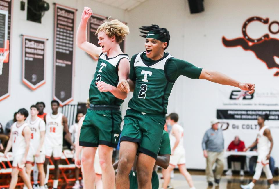 Trinity's Avery Frasher, left, and Drae Vasser celebrate after the Shamrocks rallied to win, 75-71, Tuesday night at DeSales High School.