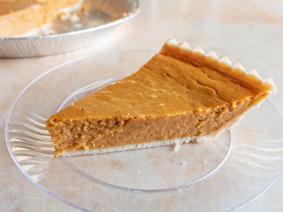 Costco pumpkin-pie slice on a clear plate