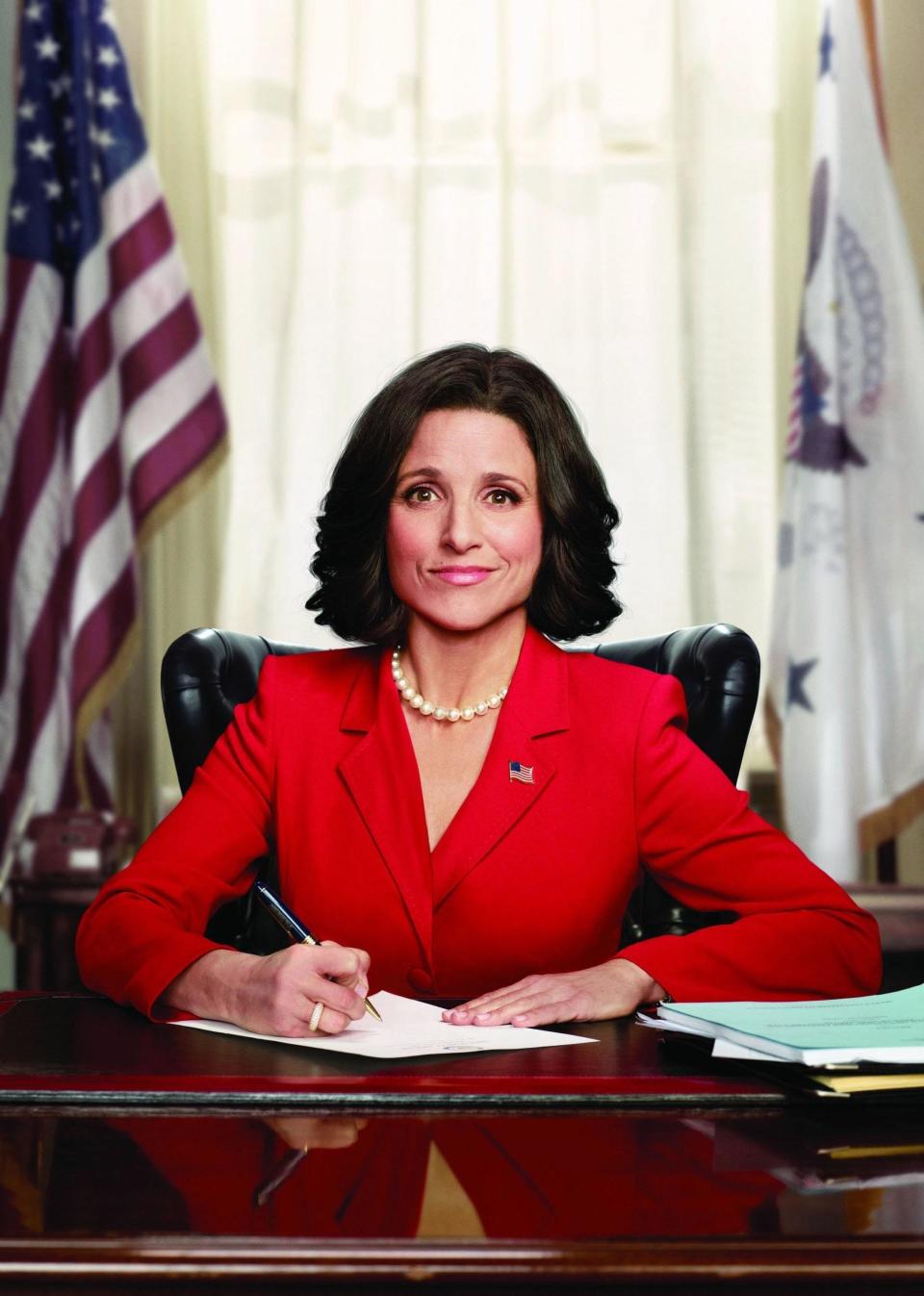 Julia Louis-Dreyfus in Veep sitting at a desk