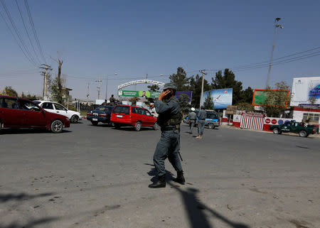 Afghan policemen stand guard outside of Kabul Airport after rockets exploded in Kabul, Afghanistan September 27, 2017. REUTERS/Mohammad Ismail