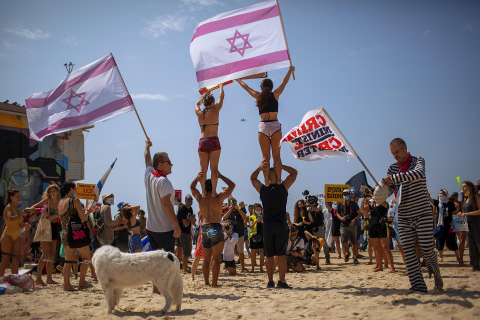 People protest against government's decision to close beaches during the three-week nationwide lockdown due to the coronavirus pandemic, in Tel Aviv, Israel, Saturday, Sept 19, 2020. Israel went back into a full lockdown on Friday to try to contain a coronavirus outbreak that has steadily worsened for months as its government has been plagued by indecision and infighting. (AP Photo/Oded Balilty)