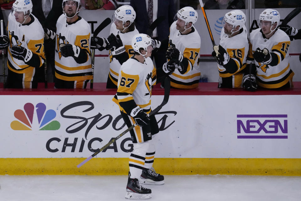 Pittsburgh Penguins right wing Rickard Rakell (67) celebrates with teammates after scoring a goal during the second period of an NHL hockey game against the Chicago Blackhawks in Chicago, Sunday, Nov. 20, 2022. (AP Photo/Nam Y. Huh)