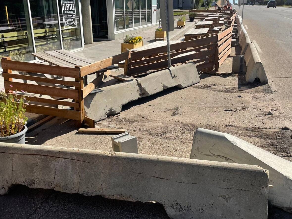 Katy Ingraham, owner of Fleisch Delikatessen says an overnight police-involved high speed chase left her patio damaged and she was not contacted by EPS. (Katy Ingraham/Twitter - image credit)