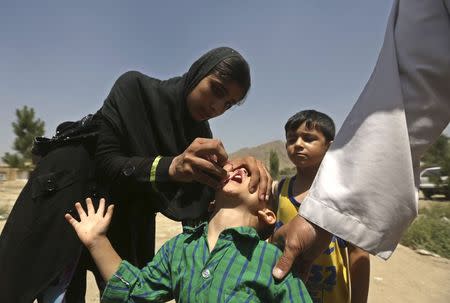 A boy receives polio vaccination drops during an anti-polio campaign in Kabul, in this file picture taken August 18, 2014. REUTERS/Omar Sobhani