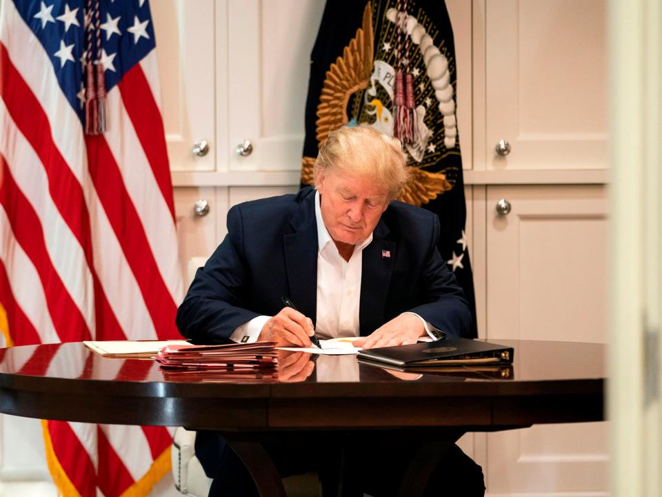 This White House handout photo released 4 October 2020 shows US president Donald Trump working in the Presidential Suite at Walter Reed National Military Medical Centre in Bethesda, Maryland on 3 October 2020, after testing positive for Covid-19 ((AFP photo /The White House/Joyce N. Boghosian/Handout))