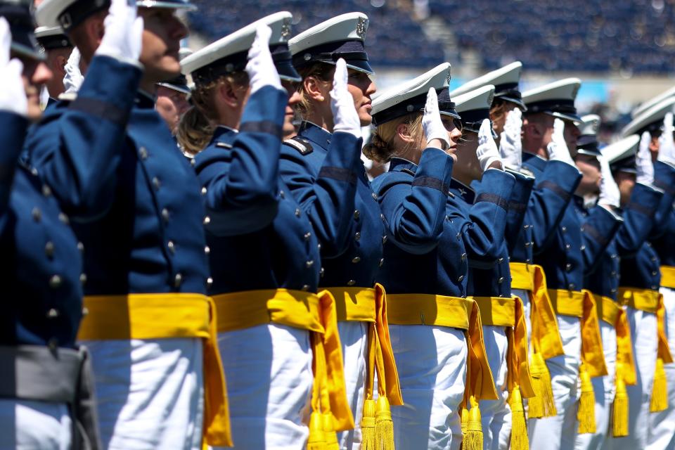 Air Force Academy cadets take their oath of office during the graduation ceremony May 25, 2022, in Colorado Springs, Colorado. The academy has now hired a contractor to monitor cadets' social media, an new effort to combat extremism as well as bullying and other misconduct.