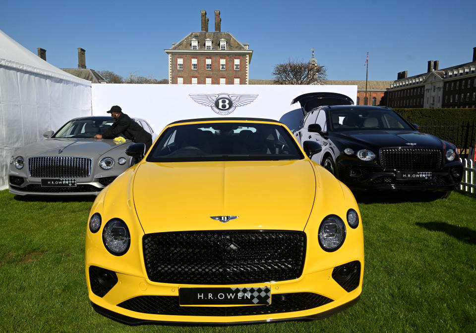 FILE PHOTO: A worker cleans a Bentley car on display at the Salon Prive, a three day automobile event which showcases both new and classic luxury and sports vehicles, at the Royal Chelsea Hospital in London, Britain, April 20, 2023. REUTERS/Toby Melville