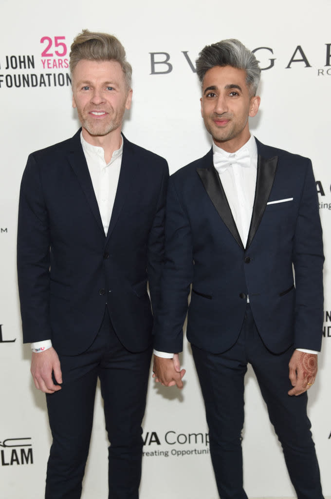 Rob and Tan France holding hands at an event