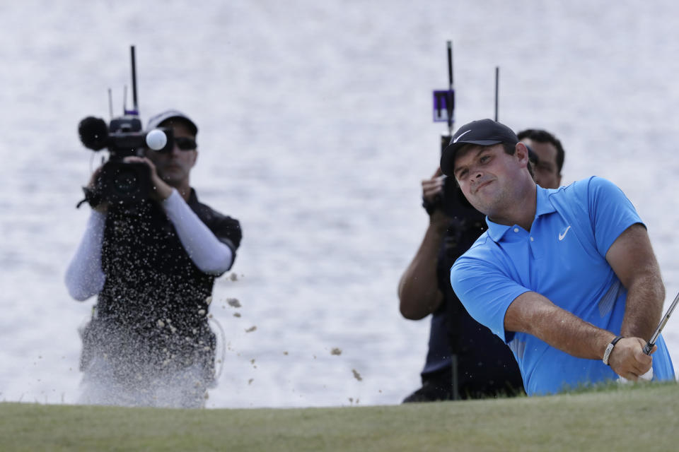 Patrick Reed hits out of a bunker on the fourth hole in the final round of the Northern Trust golf tournament at Liberty National Golf Course, Sunday, Aug. 11, 2019, in Jersey City, N.J. (AP Photo/Mark Lennihan)