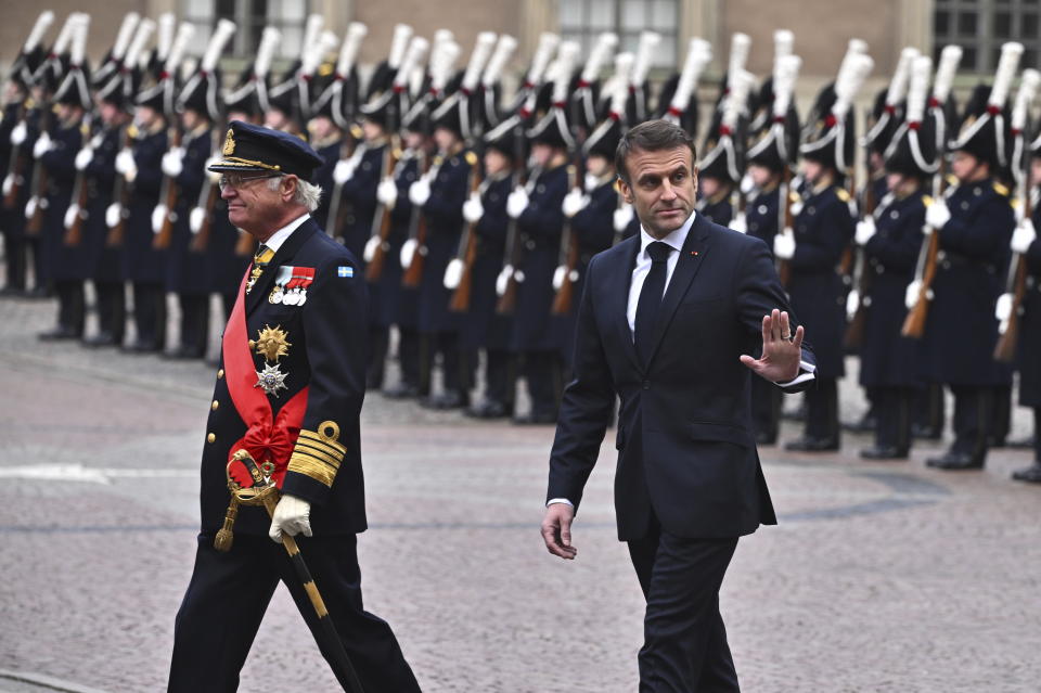French President Emmanuel Macron, right, and Sweden's King Carl XVI Gustaf inspect the Grenadier Guards of the Life Guards during a welcome ceremony at the Inner Courtyard of the Royal Palace in Stockholm, Sweden, Tuesday Jan. 30, 2024. France’s President Emmanuel Macron started a two-day state visit in Stockholm during which he will meet Swedish prime minister, Ulf Kristersson, and the country’s monarch, King Carl XVI Gustaf. (Claudio Bresciani/TT via AP)