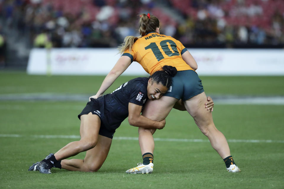 Risi Pouri-Lane of New Zealand tackles Isabella Nasser of Australia during the women's World Rugby Sevens Series 2024 cup final between Australia and New Zealand, in Singapore, on Sunday, May 5, 2024. (AP Photo/Suhaimi Abdullah)
