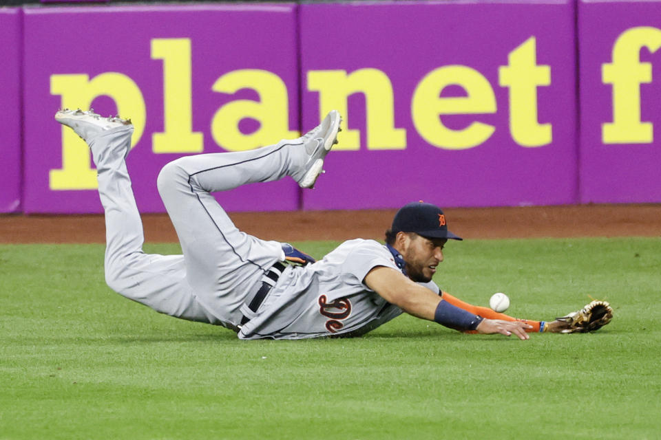 Detroit Tigers' Victor Reyes makes a diving attempt on a single by Cleveland Indians' Greg Allen during the eighth inning of a baseball game, Saturday, Aug. 22, 2020, in Cleveland. (AP Photo/Ron Schwane)