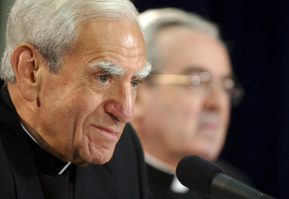 FILE - Cardinal Anthony Bevilacqua listens to a reporter's question as Archbishop Justin F. Rigali, right, listens at a news conference in Philadelphia, July 15, 2003. Monsignor William Lynn, the longtime secretary for clergy, was accused of sending a known predator, named on a list of problem priests he had prepared for Cardinal Bevilacqua, to an accuser’s northeast Philadelphia parish. Lynn served nearly three years in state prison before appeals courts threw out his felony child endangerment conviction, and he pleaded no contest in November 2022 to a misdemeanor charge of failing to turn over records to the 2002 grand jury. (AP Photo/Jacqueline Larma, File)