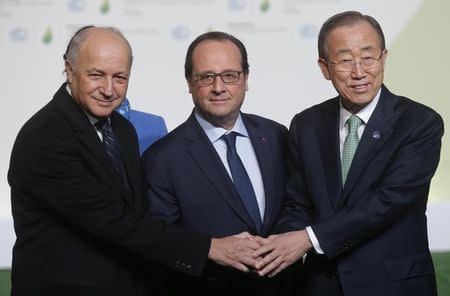 French President Francois Hollande (C) and French Foreign Affairs Minister Laurent Fabius (L) welcome United Nations Secretary General Ban Ki-moon as he arrives for the opening day of the World Climate Change Conference 2015 (COP21) at Le Bourget, near Paris, France, November 30, 2015. REUTERS/Christian Hartmann