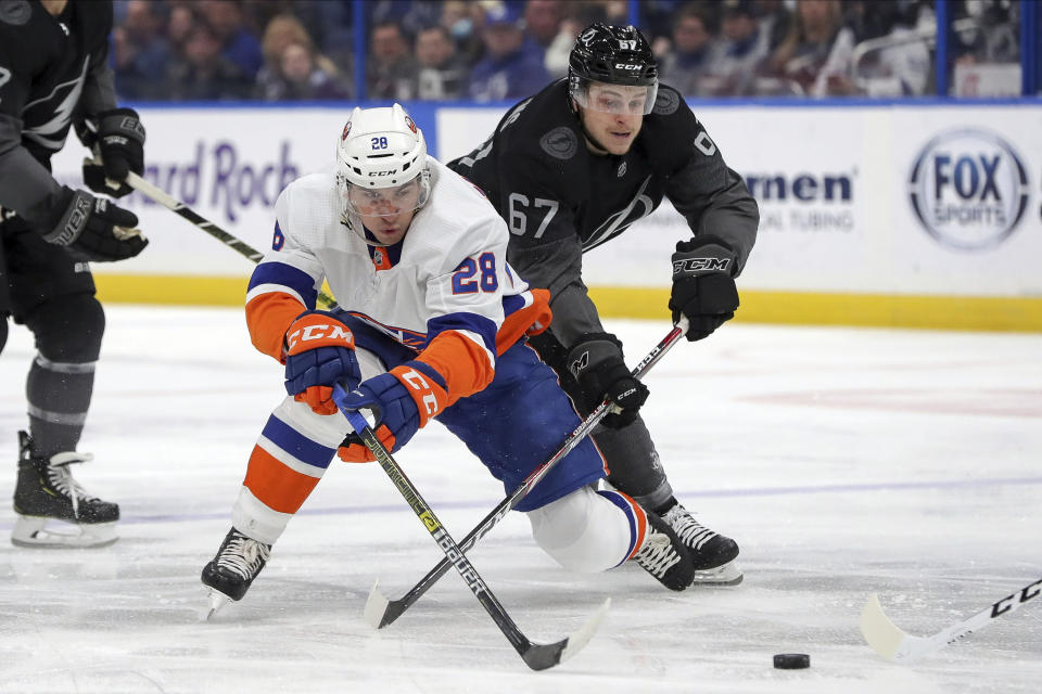New York Islanders' Michael Dal Colle avoids a check from Tampa Bay Lightning's Mitchell Stephens during the first period of an NHL hockey game Saturday, Feb. 8, 2020, in Tampa, Fla. (AP Photo/Mike Carlson)