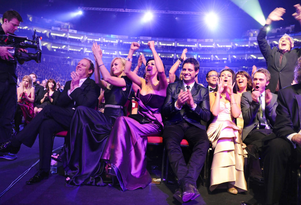 The cast of Coronation Street celebrate Craig Gazey winning the best newcomer award during the National Television Awards 2010, at the 02 Arena, London.