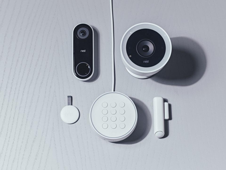 Nest’s new security system (bottom), video doorbell (left), and outdoor security camera (right).