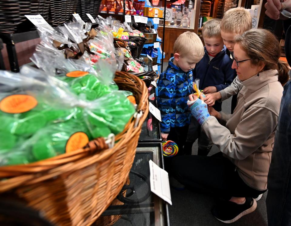 Kristin Cressman of Worcester picks out candy with her sons, Judah, 4, Levi, 6, and Joshua, 9, at Hebert's Candy Mansion in Shrewsbury.