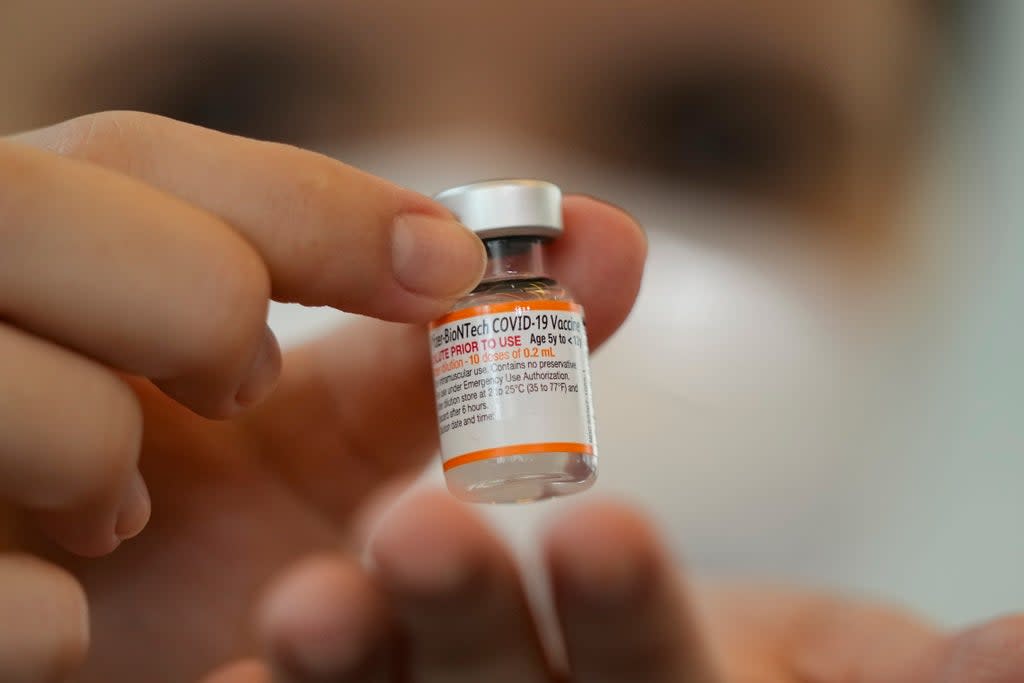 A health worker holds a vial of the Pfizer vaccine for COVID-19 (AP)