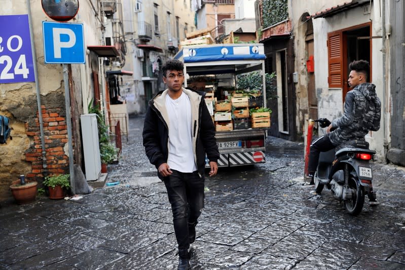 Nico Rodrigues, 21, walks on the street, close to the Santa Maria della Sanita Basilica in the Rione Sanita neighbourhood, in Naples