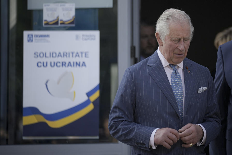 Britain's Prince Charles exits a center for refugees fleeing the war in neighboring Ukraine, at the Romexpo convention center, in Bucharest, Romania, Wednesday, May 25, 2022. (AP Photo/Vadim Ghirda)