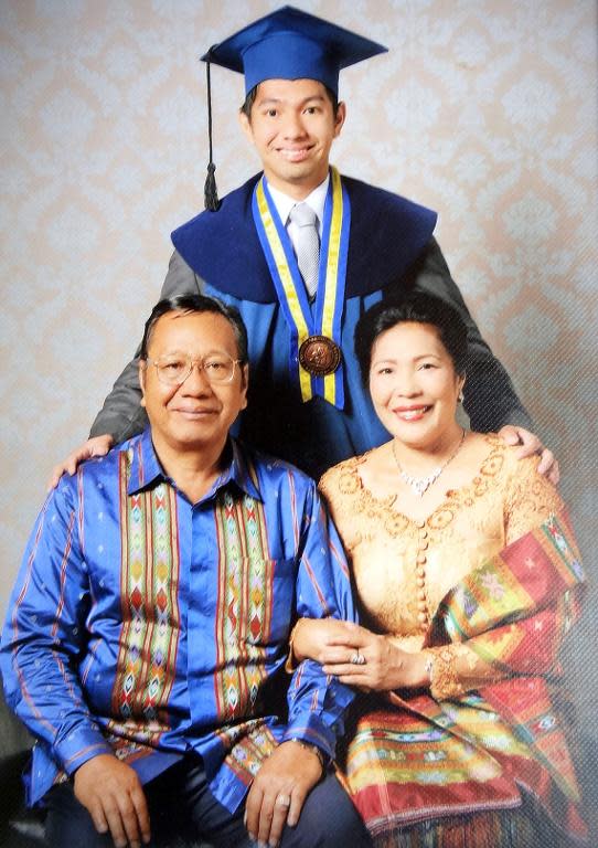 This reproduction of a handout photograph released by the family of Firman Siregar on March 12, 2014 in Medan, located on Sumatra island, shows passenger of the missing Malaysia Airlines flight MH370, Indonesian Firman Siregar with his parents