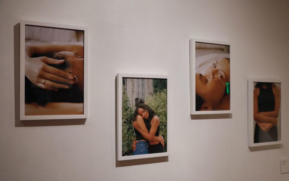 A series of photographs on a white wall.