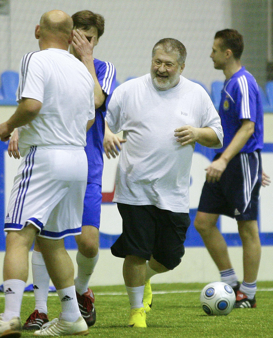 In this photo taken in Feb. 26, 2010, Ukrainian oligarch Igor Kolomoyskiy, center, plays soccer in Kiev, Ukraine. For years, Ukraine’s business tycoons have challenged the central authorities in Kiev, fighting, plotting and scheming to enlarge and maintain their multimillion-dollar empires. But when President Vladimir Putin’s troops invaded the pro-Russian strategic Black Sea peninsula of Crimea and held massive military exercises near the border with eastern Ukraine, the country’s richest men put their rivalries aside, rallied behind the new government in Kiev and took up governors’ posts in the east of the country to counter possible Russian aggression there. (AP Photo/Andriy Lukatsky)