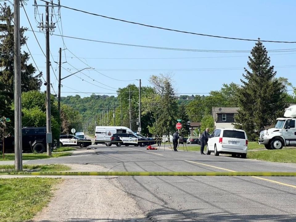 Police and investigators with the Special Investigations Unit could be seen outside a home in Stoney Creek Sunday, where three people died, including two tenants and one man who police say had shot them. (Aura Carreño Rosa/CBC - image credit)