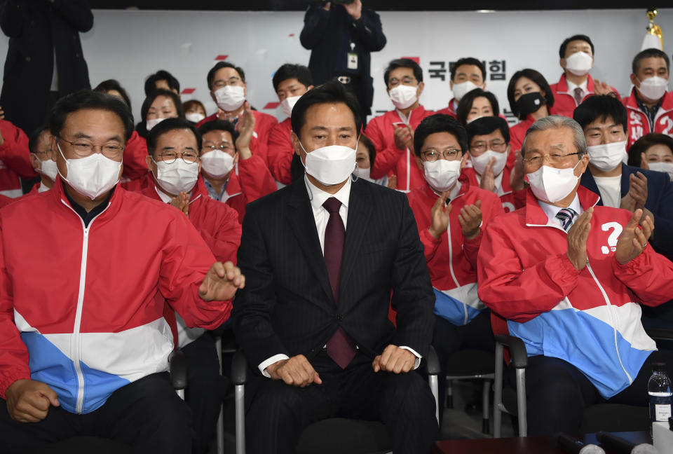 Oh Se-hoon, candidate of the main opposition People Power Party, celebrates with party members while watch monitors broadcasting the results of exit polls for the Seoul mayoral by-election at the party's headquarters Wednesday, April 7, 2021, in Seoul, South Korea. (Song Kyung-seok/Pool Photo via AP)