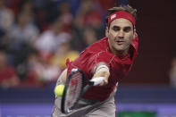 Roger Federer of Switzerland hits a return shot against Albert Ramos-Vinolas of Spain during their men's singles match at the Shanghai Masters tennis tournament at Qizhong Forest Sports City Tennis Center in Shanghai, China, Tuesday, Oct. 8, 2019. (AP Photo/Andy Wong)