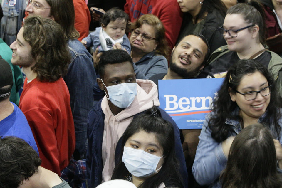 Supporters wear face masks as they attend a campaign event of Democratic presidential candidate Sen. Bernie Sanders, I-Vt., at Los Angeles Convention Center in Los Angeles Sunday, March 1, 2020. (AP Photo/Damian Dovarganes)