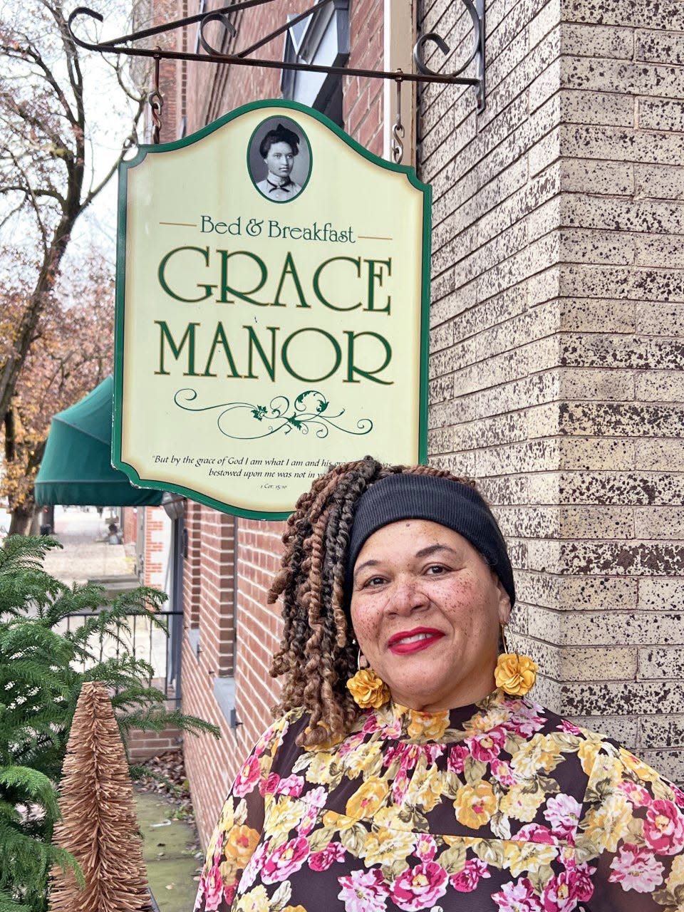 York’s Joanne Wilmore stands in front of her West Market Street bed-and-breakfast, Grace Manor. “Grace” comes from Wilmore’s grandmother, and the image shows Wilmore’s great-grandmother Ethel. “These matriarchs spent their lives working for others with little to no intentionally built space for their own rest, refuge and enjoyment,” Wilmore wrote on Sojourn Noir’s website.