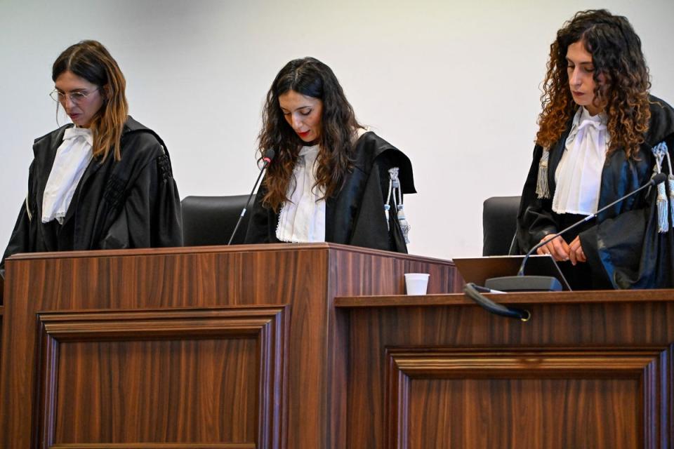 Judge Brigida Cavasino, flanked by judges Claudia Caputo, left, and Germana Radice, reads the verdicts (AP)