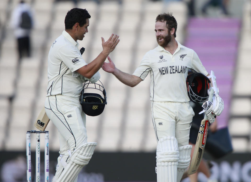 New Zealand's captain Kane Williamson, right, and Ross Taylor celebrate their win on the sixth day of the World Test Championship final cricket match between New Zealand and India, at the Rose Bowl in Southampton, England, Wednesday, June 23, 2021. (AP Photo/Ian Walton)