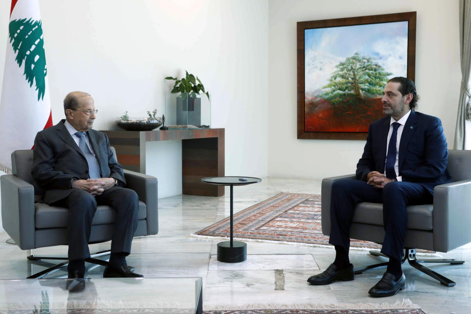 In this photo released by Lebanon's official government photographer Dalati Nohra, Lebanese President Michel Aoun, left, meets with Lebanese Prime Minister-Designate Saad Hariri, at the presidential palace, in Baabda, east of Beirut, Lebanon, Wednesday, July 14, 2021. (Dalati Nohra/Lebanese Official Government via AP