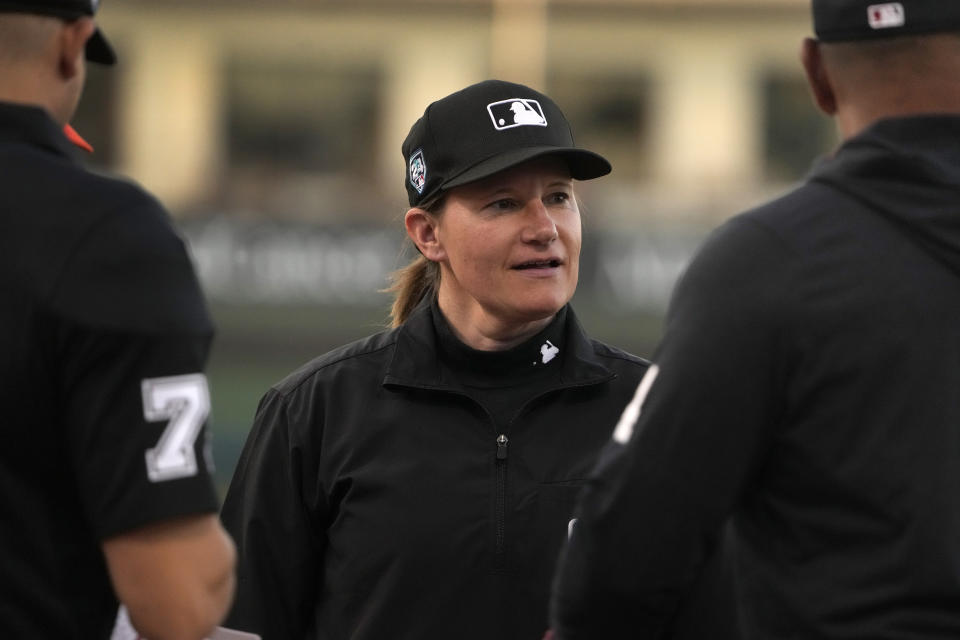Umpire Jen Pawol participates in the lineup card exchange before the start of a spring training baseball game between the Washington Nationals and the Houston Astros Saturday, Feb. 24, 2024, in West Palm Beach, Fla. Pawol took a big step toward breaking the gender barrier for Major League Baseball umpires when she became the first woman in 17 years to work a big league spring training game Saturday night. (AP Photo/Jeff Roberson)