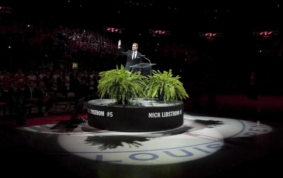 Former Detroit Red Wing Nicklas Lidstrom waves to the crowd during the retirement ceremony for his No. 5 before an NHL hockey game between the Detroit Red Wings and Colorado Avalanche at Joe Louis Arena, Thursday, March 6, 2014, in Detroit. (AP Photo/Duane Burleson)