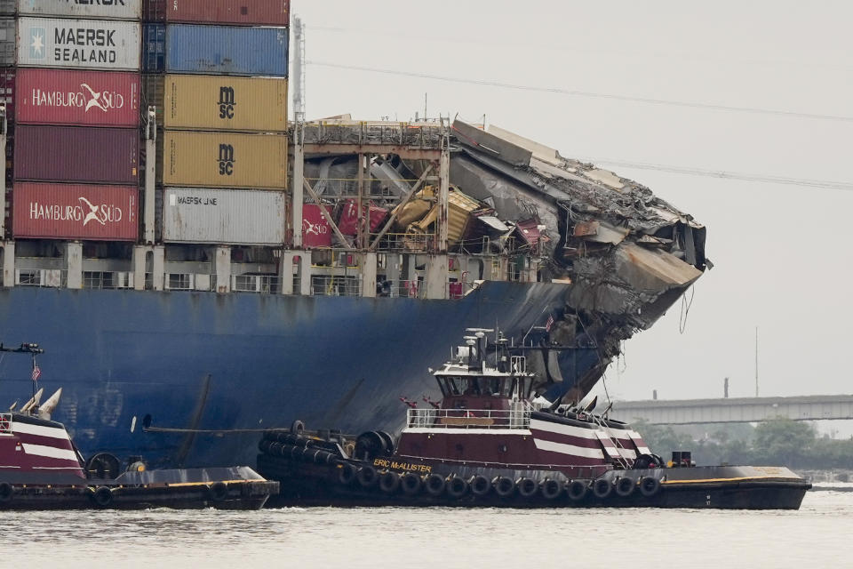Tugboats escort the cargo ship Dali after it was refloated in Baltimore, Monday, May 20, 2024. The vessel on March 26 struck the Francis Scott Key Bridge causing it to collapse and resulting in the death of six people. (AP Photo/Matt Rourke)