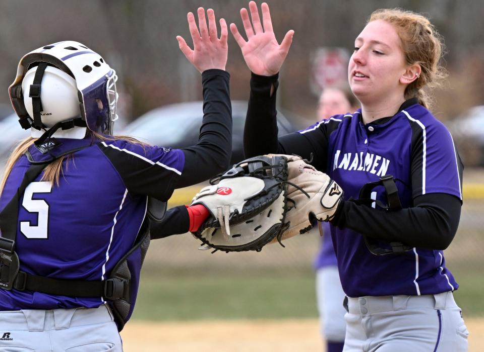 Bourne pitcher Jadyn Morrall and catcher Paige Meda high five in the late innings against Martha's Vineyard on Friday, March 31, 2023.