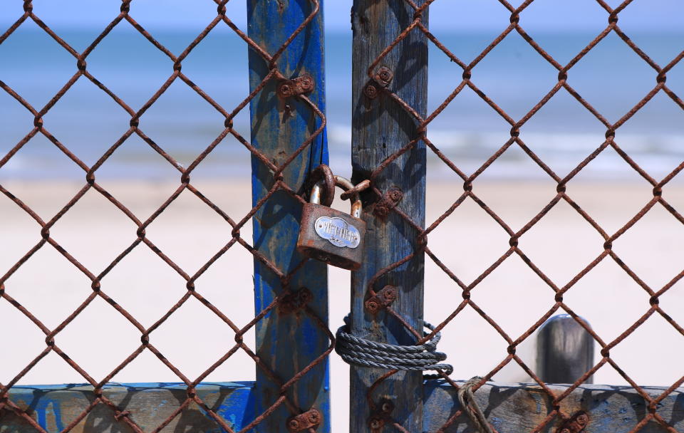 Entrance to a beach is barricaded and locked in Vung Tau, Vietnam, Monday, Sept. 20, 2021. The roadblocks and barricades make the streets of this southern Vietnamese city look like they did during the war that ended almost 50 years ago. But this time, the battle is being fought against the rampaging coronavirus. (AP Photo/Hau Dinh)