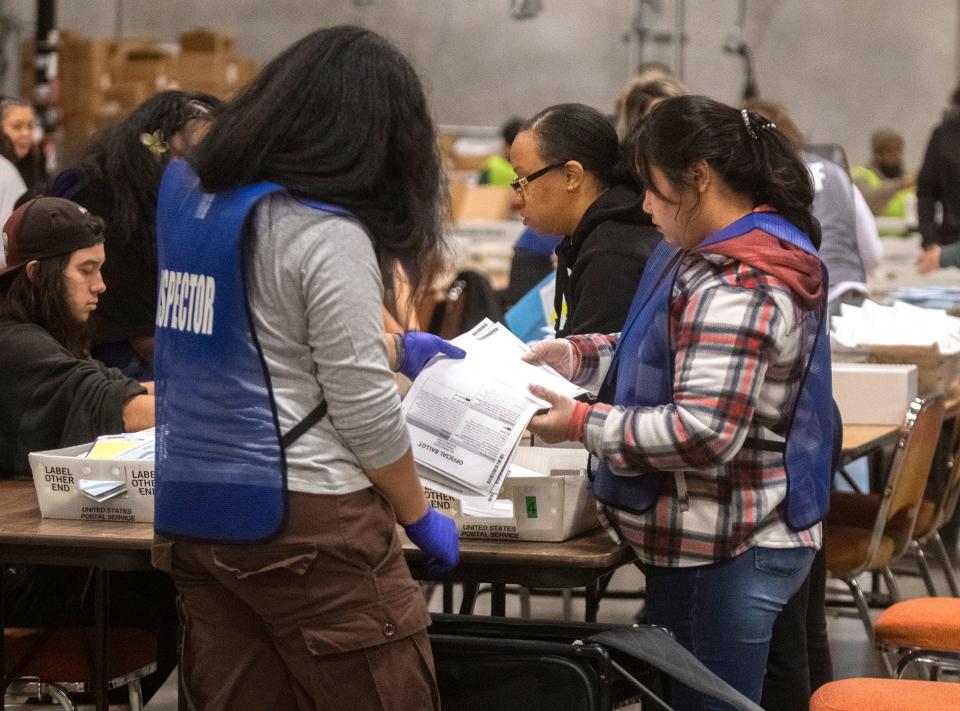 Election inspectors unload ballot boxes at the San Joaquin County Registrar of Voters ballot counting facility at the Stockton Metropolitan Airport in south Stockton on Tuesday, Nov. 8, 2022. 