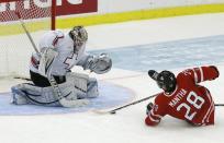 Canada's Anthony Mantha (R) is hauled down on a break-away in front of Switzerland's Melvin Nyffeler during the second period of their IIHF World Junior Championship ice hockey game in Malmo, Sweden, January 2, 2014. Matha was awarded a penalty shot. REUTERS/Alexander Demianchuk (SWEDEN - Tags: SPORT ICE HOCKEY)