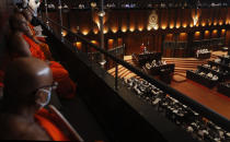 FILE- In this Aug. 20, 2020 file photo, Sri Lankan Buddhist monks watch President Gotabaya Rajapaksa, center right, deliver his policy speech in the Parliament in Colombo, Sri Lanka. A proposed amendment to Sri Lanka’s constitution that will consolidate powers in the President’s hands has raised concerns about the independence of the country’s institutions and the impact on its ethnic minorities who fear their rights could be undermined by the majoritarian will.(AP Photo/Eranga Jayawardena, File)